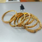 Side view of Pakistani gold plated bangles set with intricate design