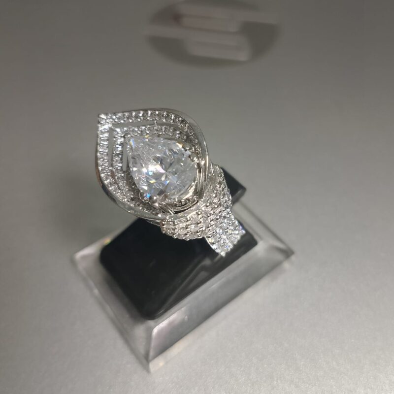 pear cut diamond engagement ring with a double halo setting and a pave band 1 e1764688629150