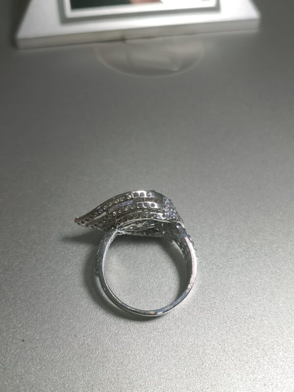 pear cut diamond engagement ring with a double halo setting and a pave band