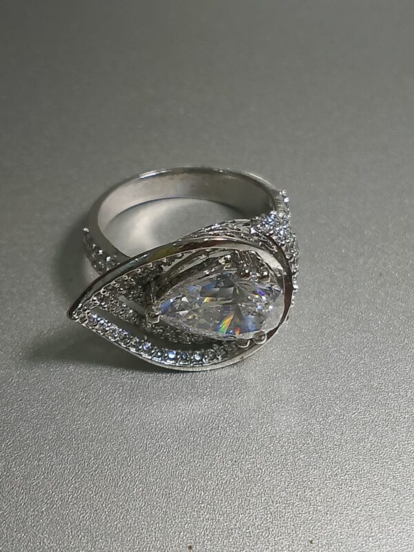 pear cut diamond engagement ring with a double halo setting and a pave band. 2