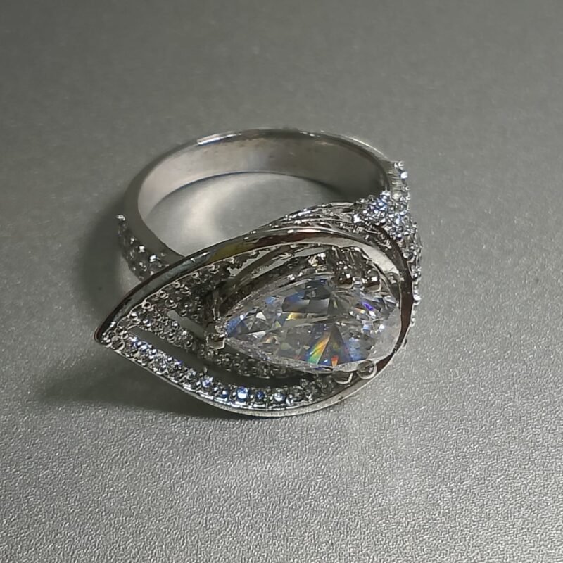 pear cut diamond engagement ring with a double halo setting and a pave band. 2 e1764688730554