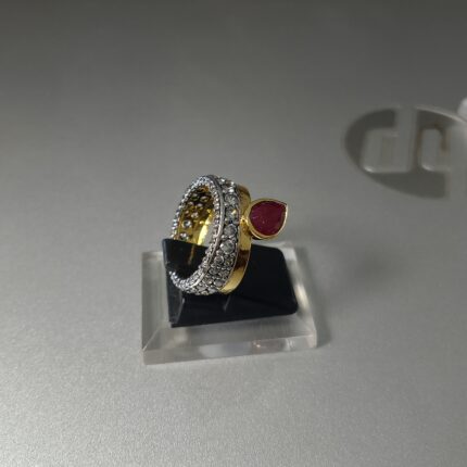 The ring features a vibrant red ruby, which can symbolize love and passion.