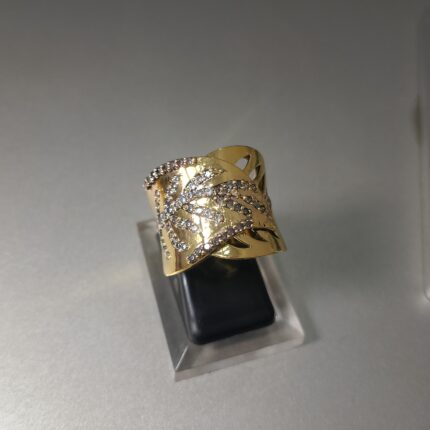 This is a wide gold ring with a leaf or vine pattern set with diamonds.