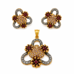 Antique gold plated maroon floral trinity pendant set with matching earrings and CZ stones Caption: Antique Gold Maroon Floral Trinity Pendant Set — Zuha Jewellery